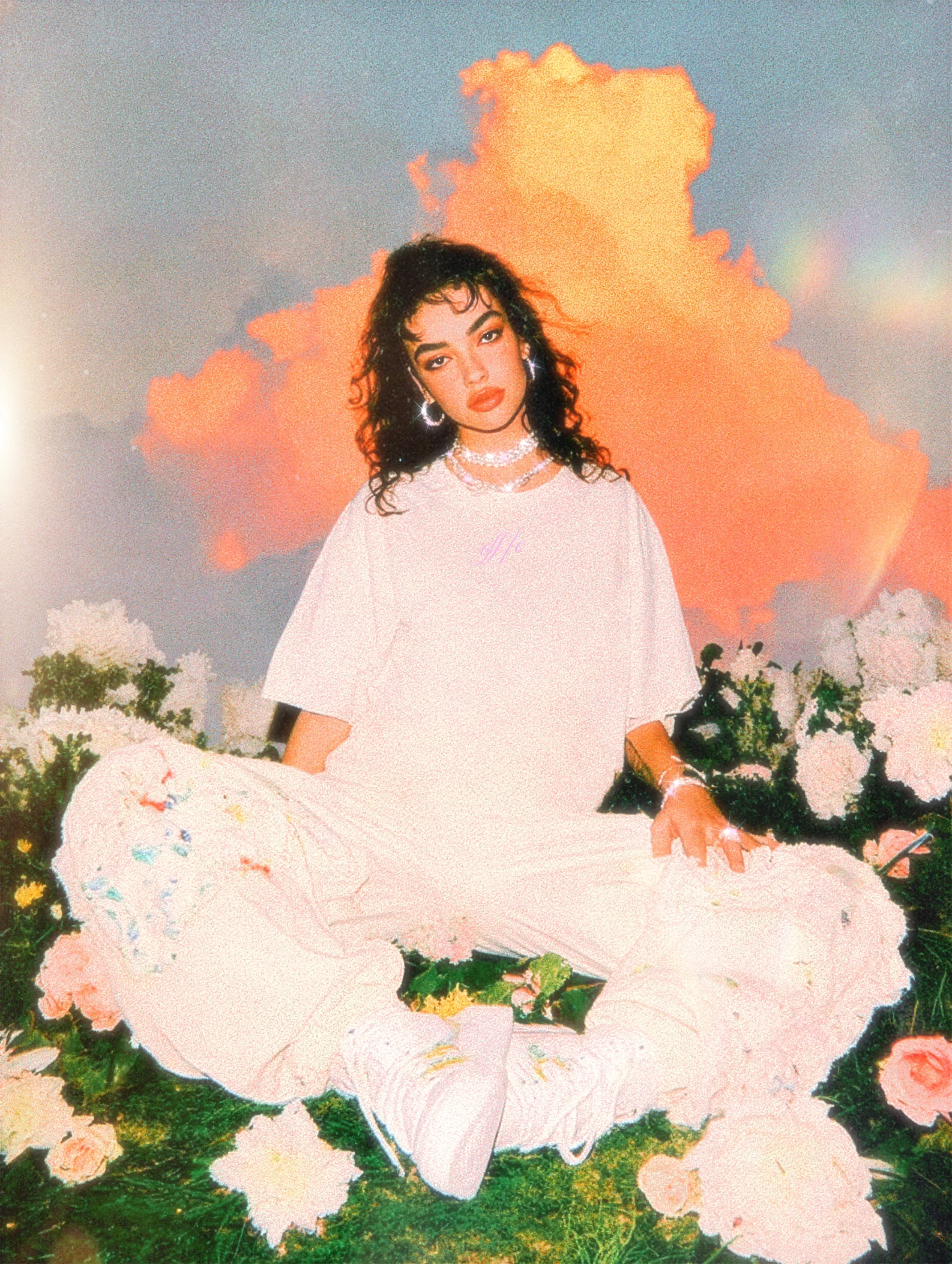 A person sitting in a field of flowers, wearing a white oversized t-shirt and floral pants, with a colorful cloud background.