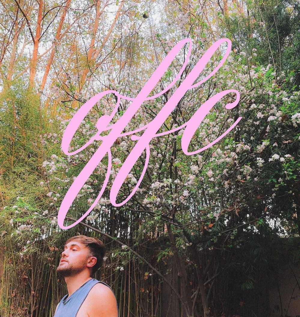 A young man stands in front of a flowering backdrop, with the word 'OFFC' in pink cursive text overlaying the image.